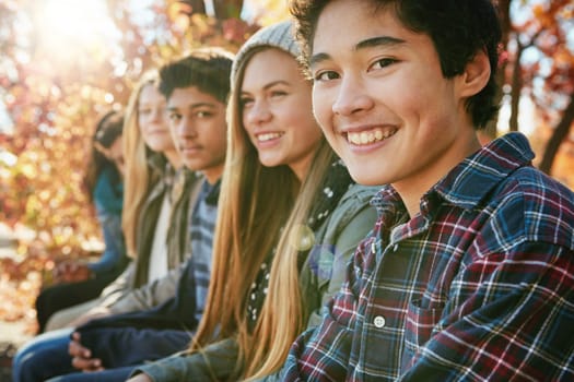 Teenager, friends and portrait in park, smile and together on holiday, nature and relax by trees. Youth culture, happy boy and gen z school kids in sunshine, woods or garden for vacation in Canada.