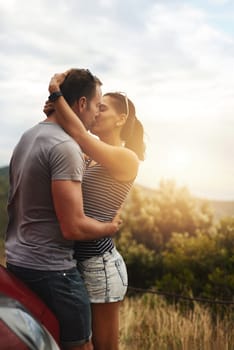 Road trip, love or couple kiss in park for date, support or care on a summer romance or adventure. Relax, hug or man with woman on outdoor holiday vacation together for bond, travel or breka.