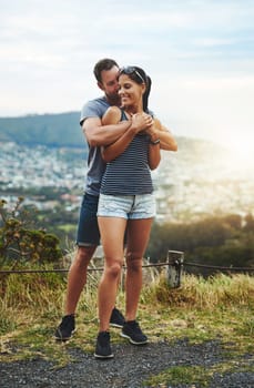 Hiking, love or couple hug in nature on date for romance or care in summer with freedom to relax. Embrace, peace or romantic man or happy woman on holiday vacation together to bond or travel in USA.