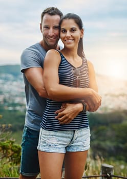 Portrait, hug and couple with happiness, outdoor and lens flare with holiday, romance and vacation. Face, man and woman with bonding, adventure and health with fun, outside and wellness with love.