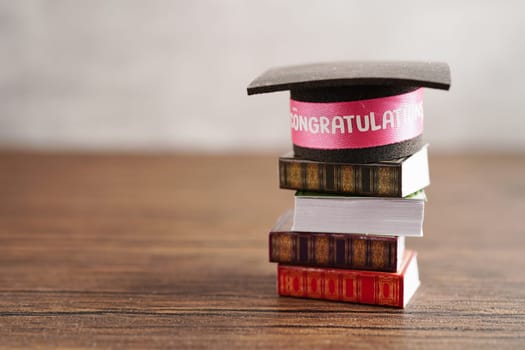 Graduation hat on book and stethoscope with copy space, doctor learning medicine university education concept.