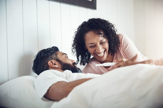 Couple, surprise and bedroom with pregnancy test, positive and bed with smile, results and excited. Man, woman and baby with stick, love and maternity for future family, parents and pregnant together.