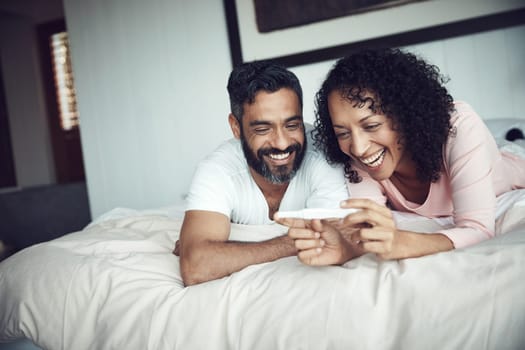 Couple, smiling and bedroom with pregnancy test, positive and bed with happiness, results and excited. Man, woman and baby with stick, love and maternity for future family, surprise and pregnancy.