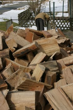 Just delivered firewood - in the background a man starts building the wooden fin for the logs