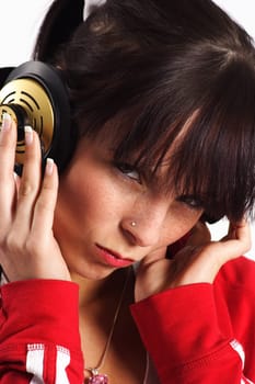 The photo shows a woman wearing headphones