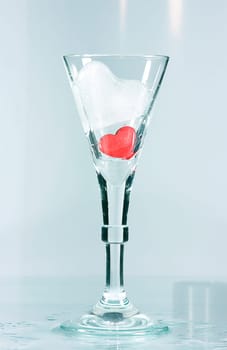 Red heart and ice heart in a glass. A Valentine's greeting.