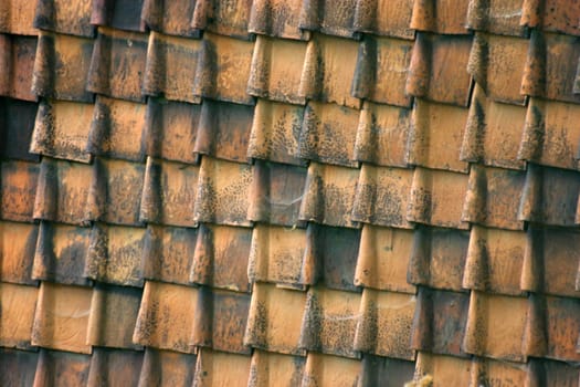 House wall covered with roof tiles