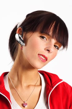 Photo shows a smiling young woman wearing a headset