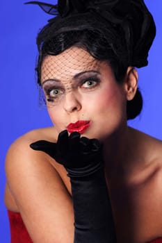Photo shows a woman in the style of the 20s,performing a kiss on the hand
