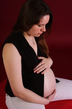 Photo shows a sedentary pregnant woman in the 9th month