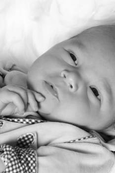 Picture shows a small baby in a thinking position