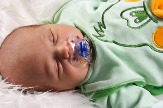 Photo shows a large baby with a pacifier