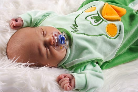 Picture shows a sleeping baby with pacifier