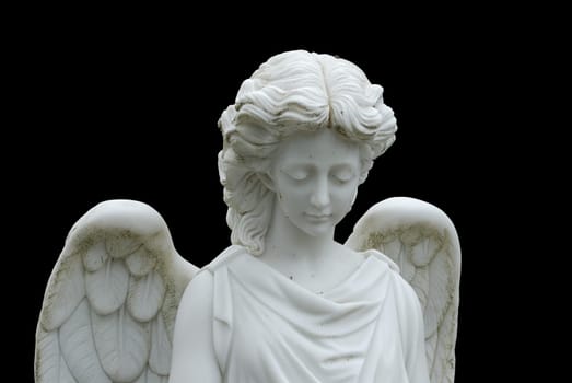 Angel statue in front of a grave. Background has been blackened with Photoshop