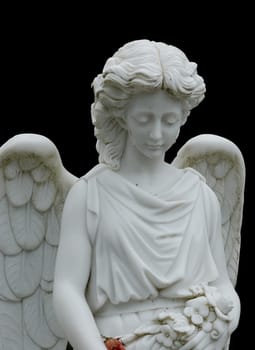 Angel statue at a grave. The background has been blackened with Photoshop