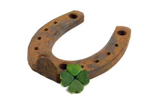 Horseshoe and shamrock isolated on white background