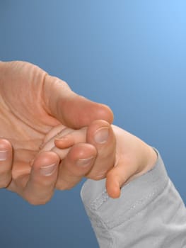 A father takes his child by the hand.