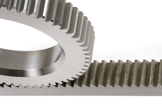Close-up of the connection between a gear and a rack isolated on a white background