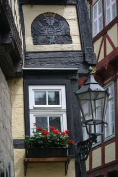 Lantern and geraniums on a half-timbered house in Quedlinburg