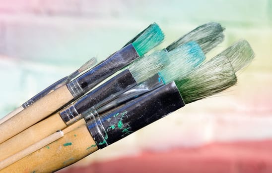 Brush in front of painting