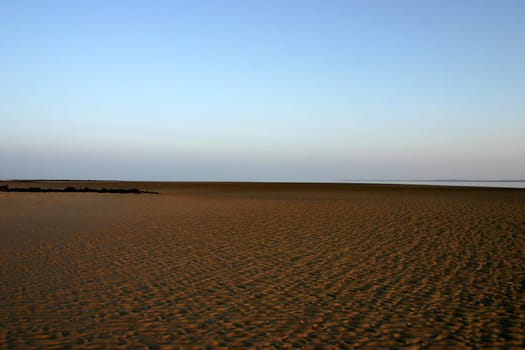 No,this is not a desert! But the North Sea beach on the island of Föhr at low tide,so that you can see the mudflats against the evening sky.