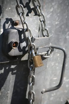 Padlock with chain on a dumpster