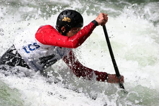 this young man kneels in the boat and paddles with a paddle... very wobbly the matter...