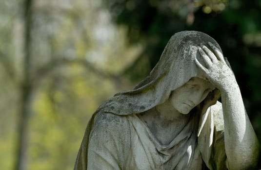 Sculpture in front of a grave.