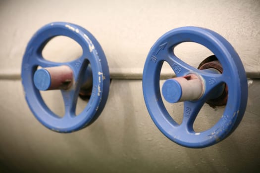 Two blue valve wheels on one machine