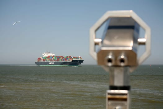 A large container ship passes the exit point at the Alte Liebe in Cuxhaven