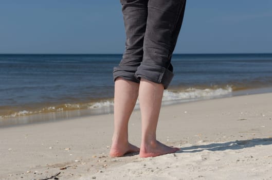 Legs of a woman on the beach