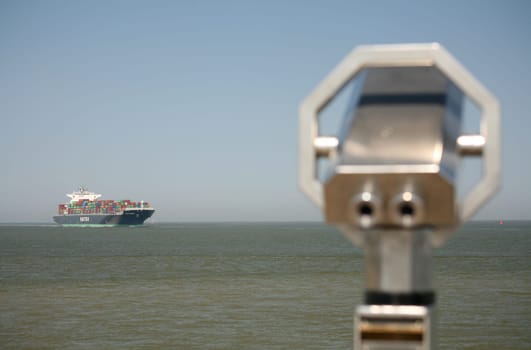 A large container ship passes the exit point at the Alte Liebe in Cuxhaven