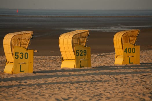 Beach chairs on the North Sea beach in the evening light