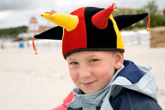 a little football fan on the beach with a fan cap for the German team