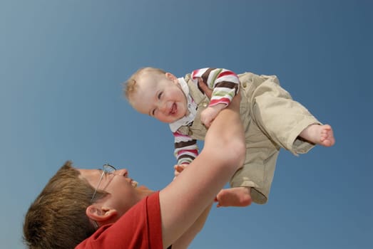 Mother and daughter in front of blue sky