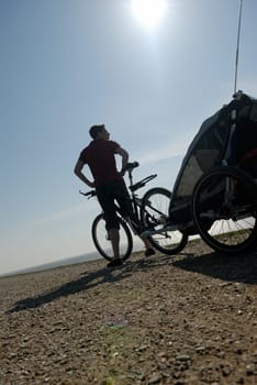 Woman with bicycle and trailer