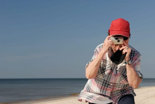 Woman taking photo on the beach of Sylt,Germany