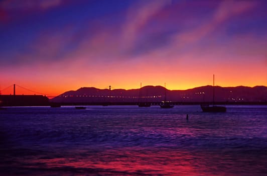 Sunset near Fisherman's Wharft. The illuminated Golden Gate can be seen in the background.