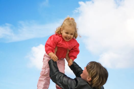 Mother and daughter playing The child is lifted up