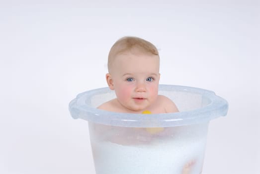 One-year-old child takes a bath (with milk)