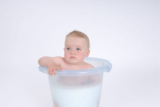 One-year-old child takes a bath (with milk)