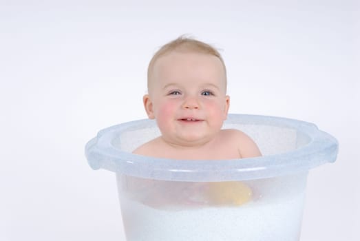 One-year-old child takes a bath (with milk)