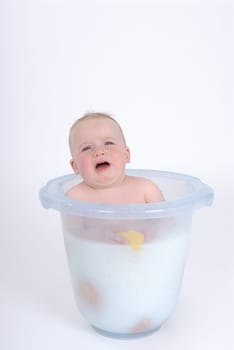 One-year-old child takes a bath (with milk)