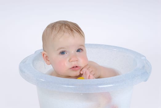 One-year-old child takes a bath (with milk)