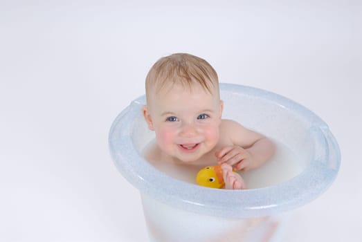 One-year-old child takes a bath (with milk)