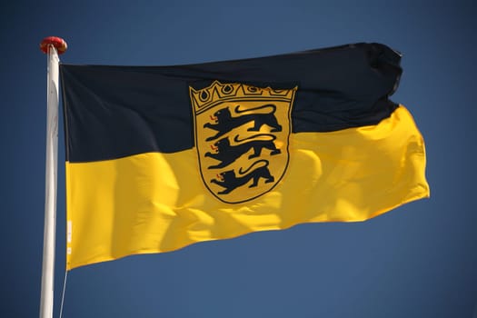State flag of Baden-Württemberg in front of a blue sky