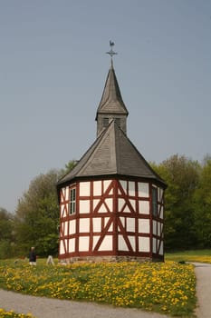 Small chapel with dandelion meadow