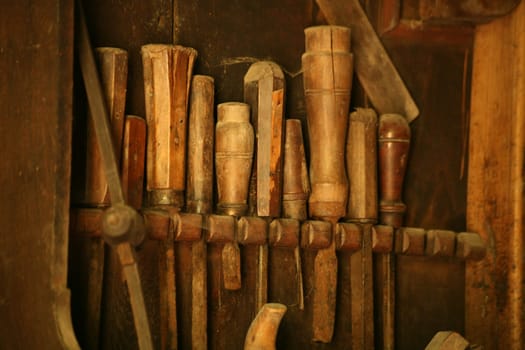 Worn chisels in a wall bracket