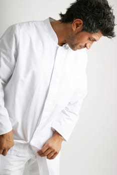 Man in white coat looking down