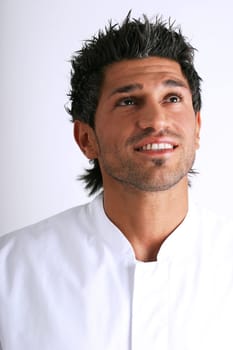 Man in white coat smiling